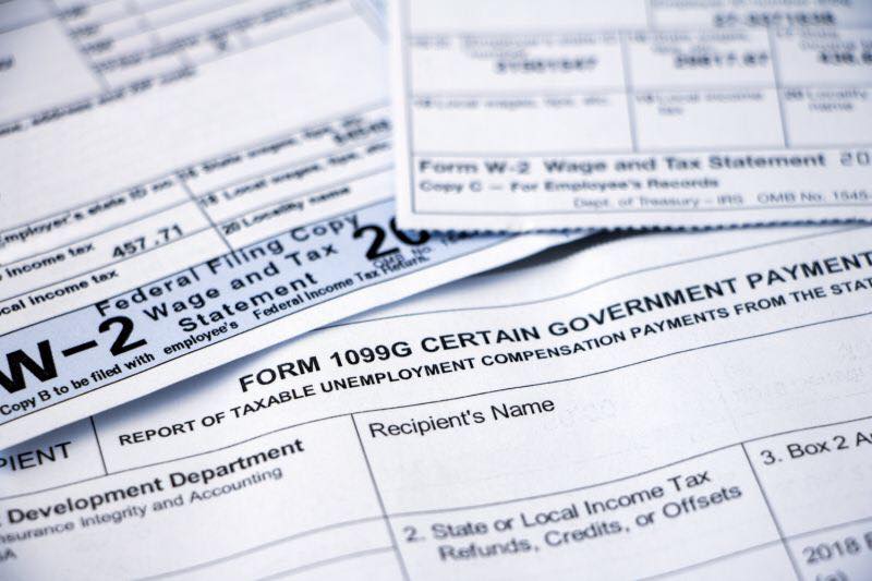 Tax forms W-2 and 1099G close-up.